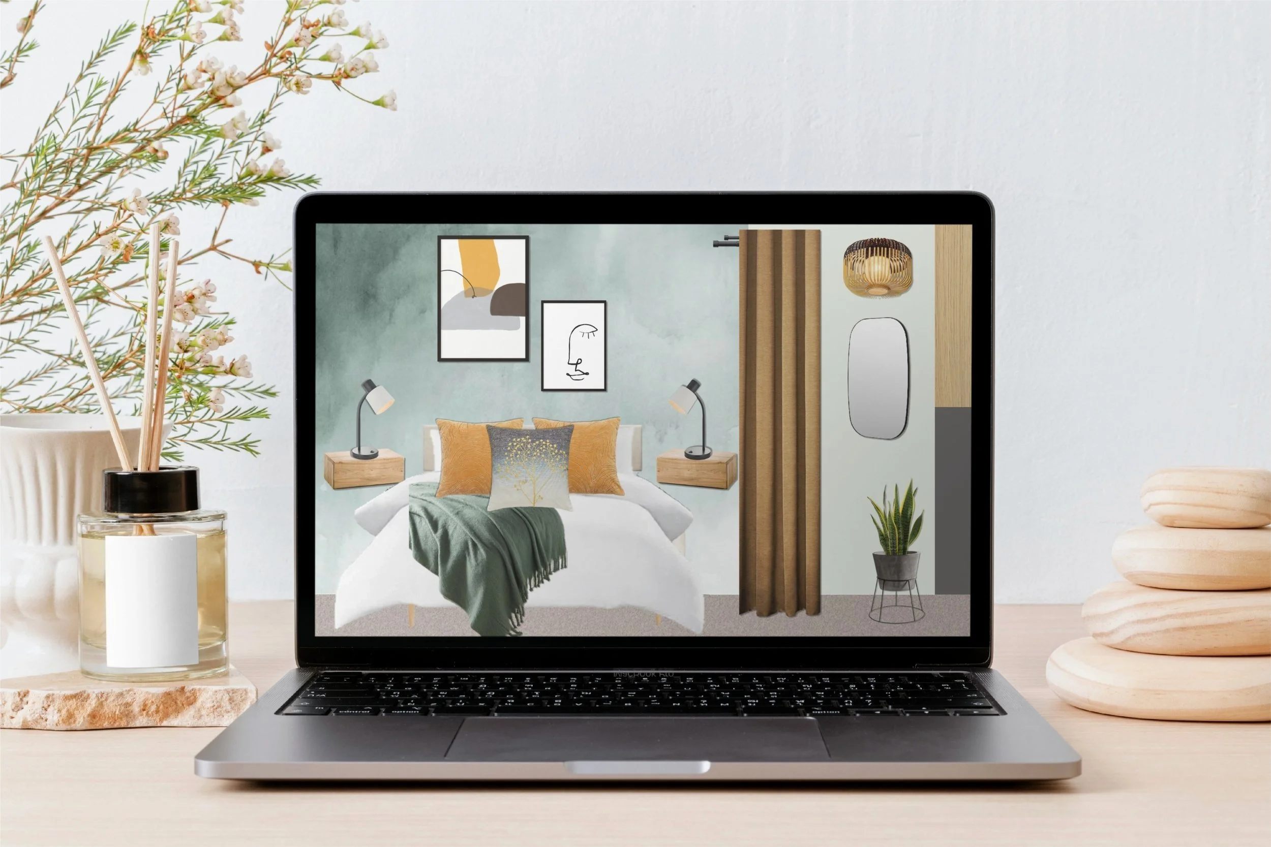 Laptop displaying a modern bedroom scene with bedding, pillows, wall art, lamps, a mirror, a potted plant, and a curtain, placed on a desk alongside decorative stones and a vase with dried flowers.