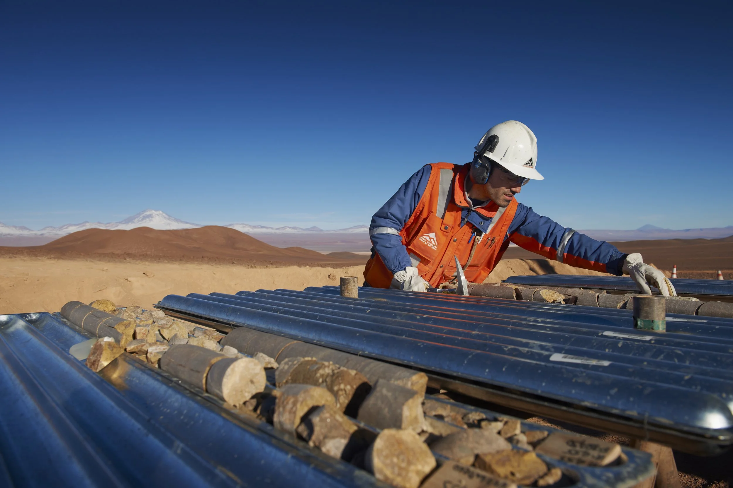    Exploration at Escondida:    A geologist inspects drill core samples against the backdrop of the Atacama Desert at BHP’s Escondida mine in northern Chile. Escondida is the world’s leading producer of copper concentrates and cathodes. (Photo: BHP) 