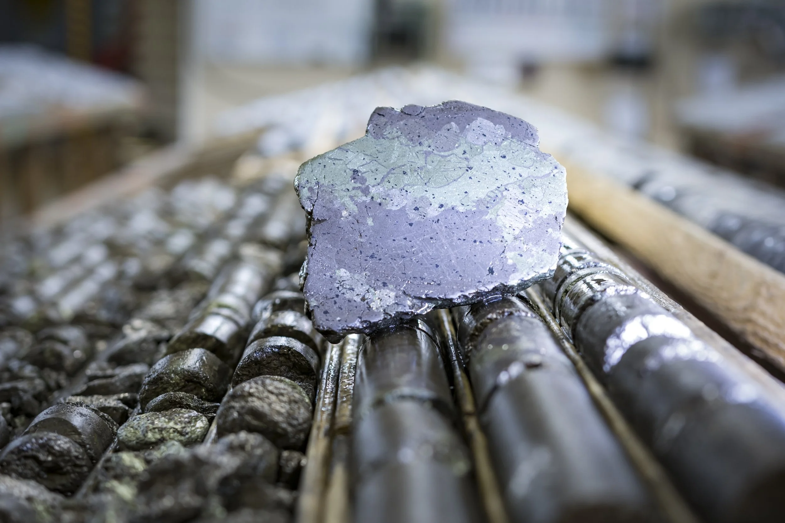    High-Grade Sulfide Ore:    A cut core sample displaying rich nickel-copper massive sulfide mineralization sits atop core trays at a Vale Base Metals exploration facility in Canada. (Photo: Vale Base Metals)  