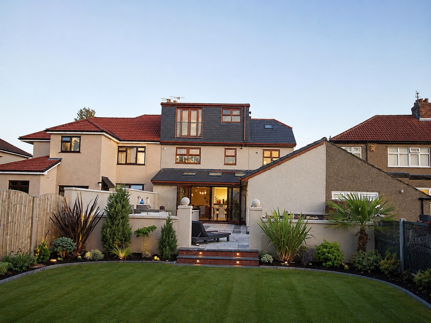 Completed rear dormer loft conversion and extension overlooking a landscaped garden in Wirral