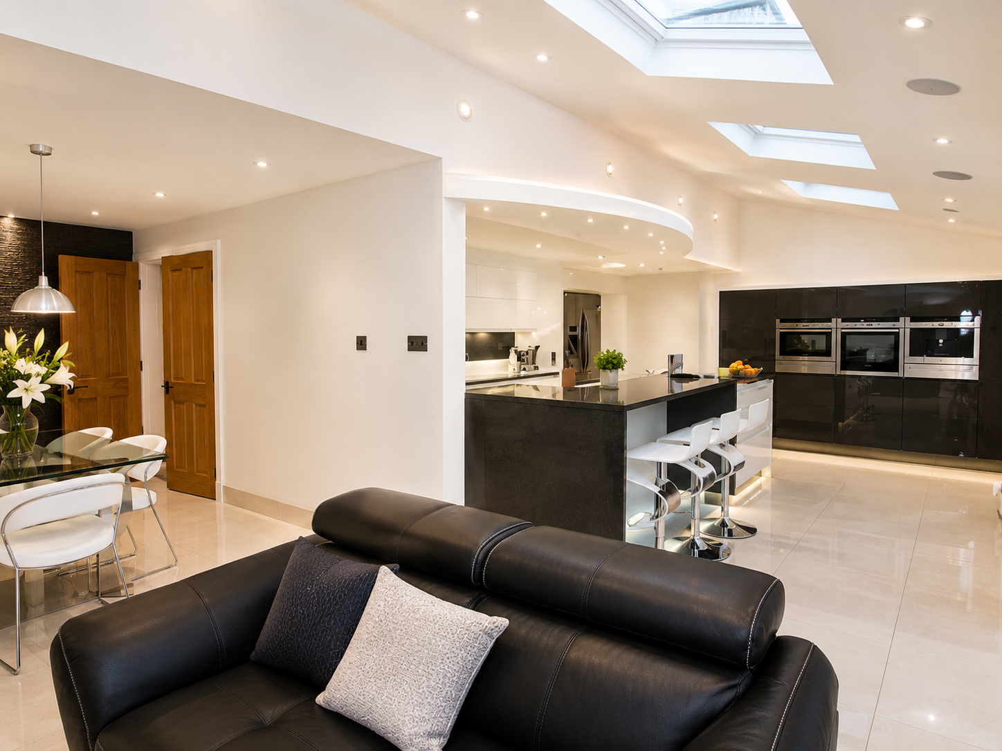 Completed open-plan kitchen and living space in Wirral with rooflights, kitchen island and contemporary finishes