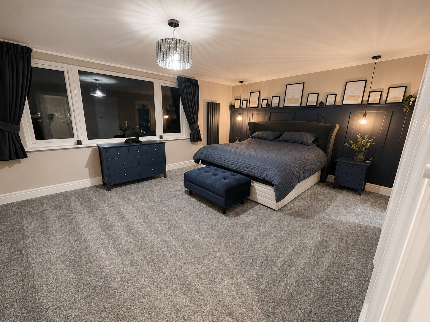 Completed loft conversion bedroom with bespoke fitted storage and feature panelling