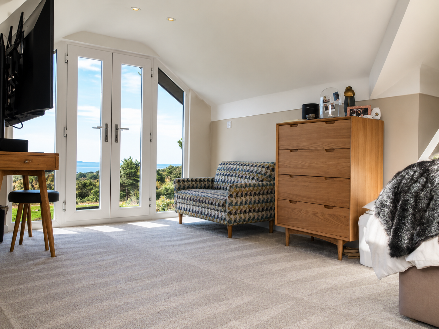 Completed loft bedroom with French doors, vaulted ceiling and far-reaching views