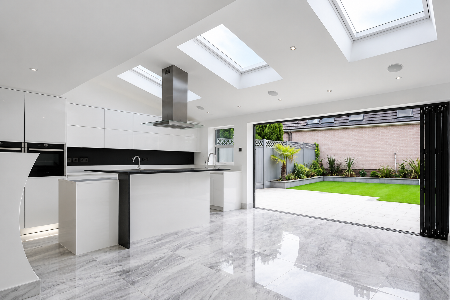 Completed kitchen extension in Wirral with rooflights and doors opening onto the garden
