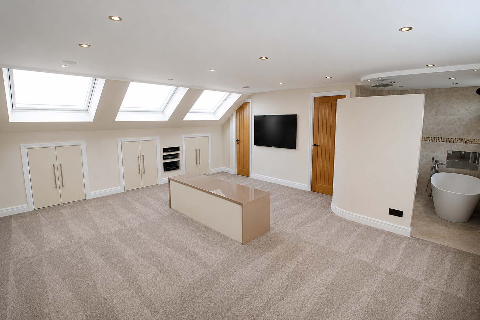 Completed loft conversion bedroom with Velux roof windows and bespoke storage