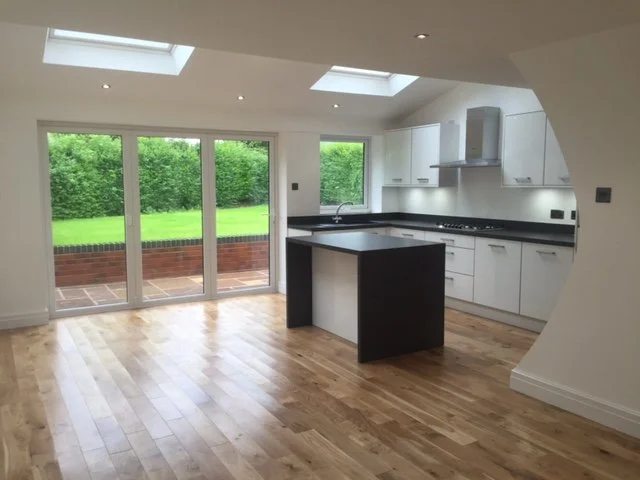 Completed kitchen extension in Wirral with rooflights and doors opening onto the garden