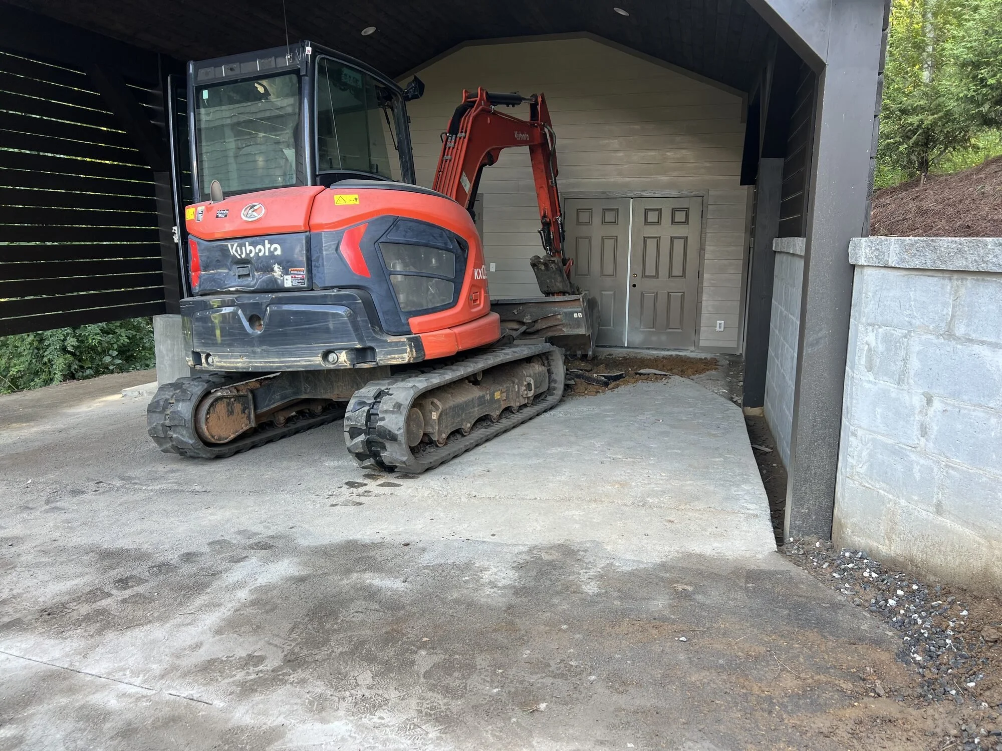 Concrete slab tear-out and site prep under a carport in Sylva, NC — excavation and grading by Black Bear Paving