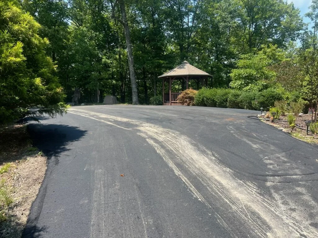 Asphalt pad and driveway beside a backyard gazebo in Bryson City, NC, installed by Black Bear Paving