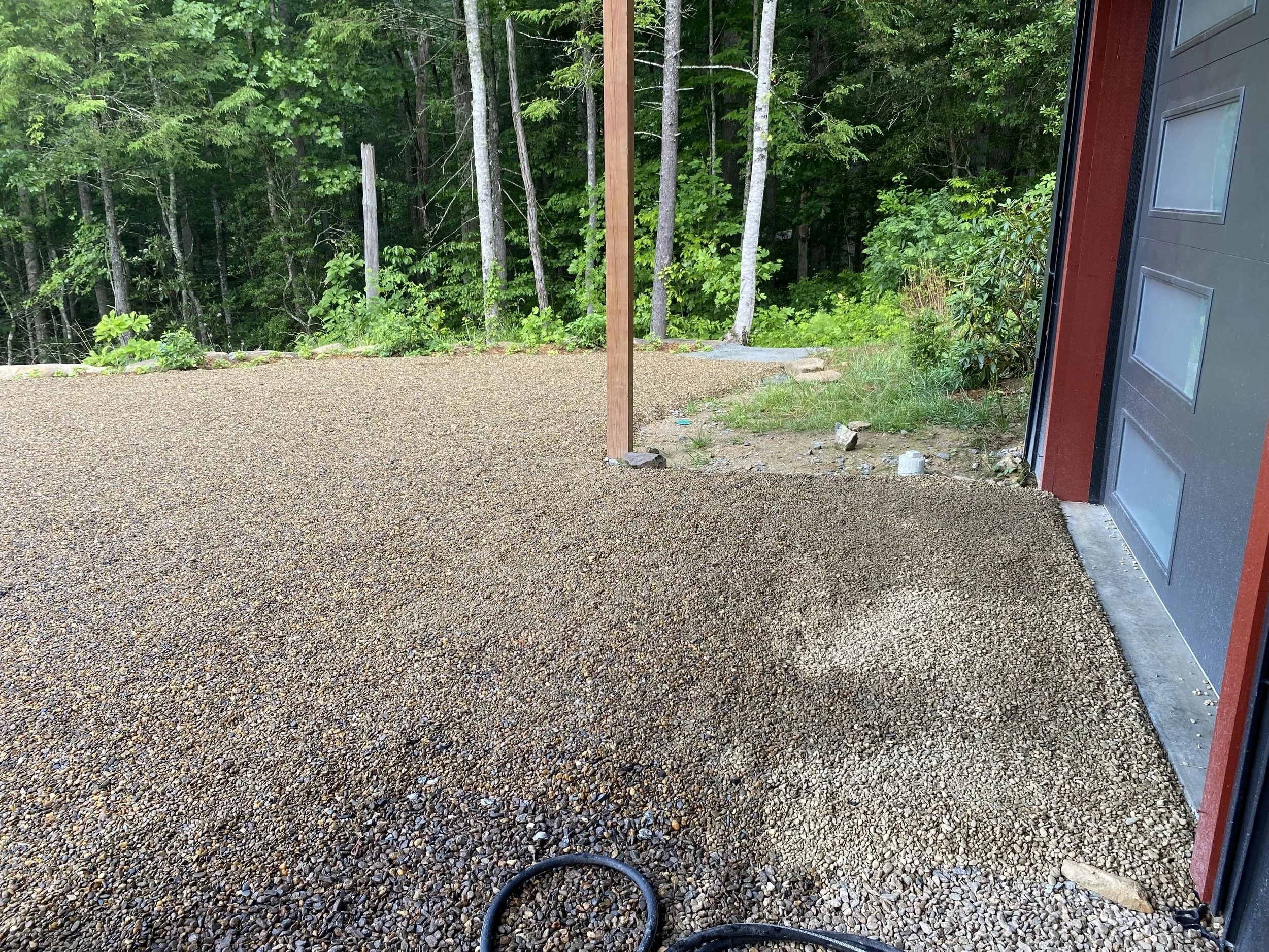 Wooded mountain property with a new gravel driveway and site work by Black Bear Paving
