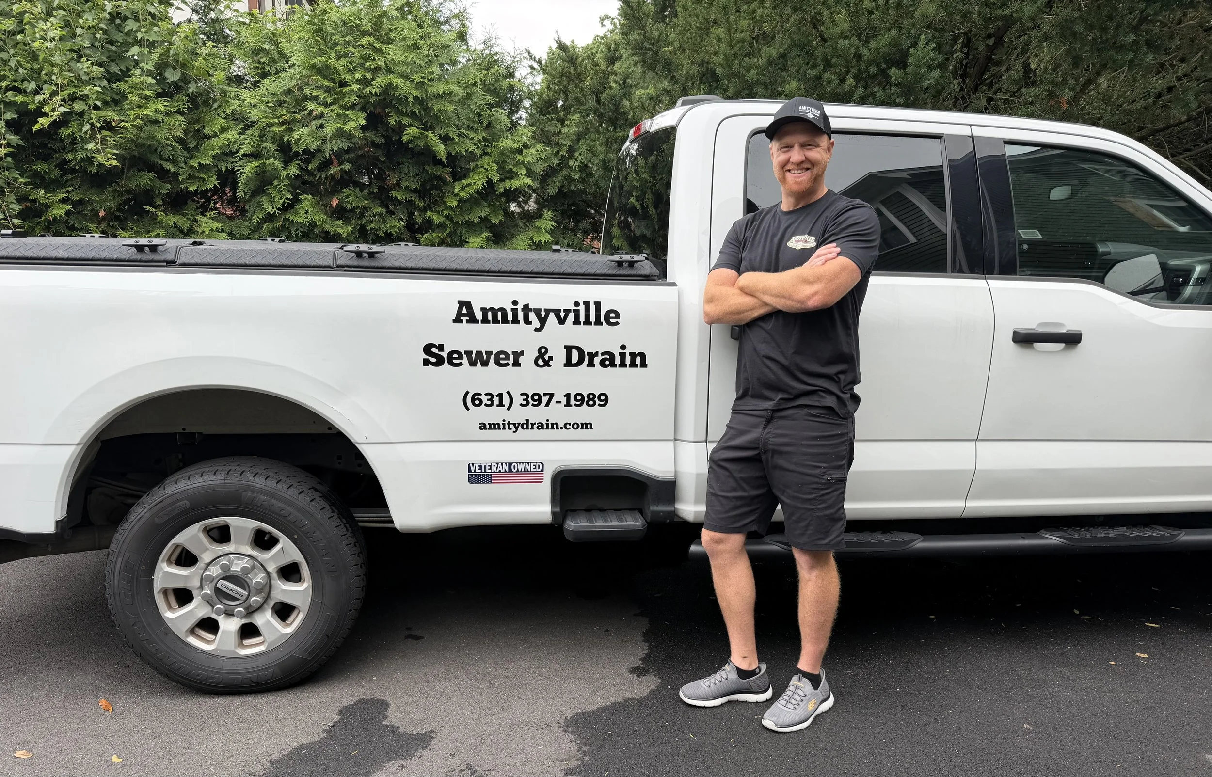 Amityville Sewer & Drain technician with service truck in Amityville, NY