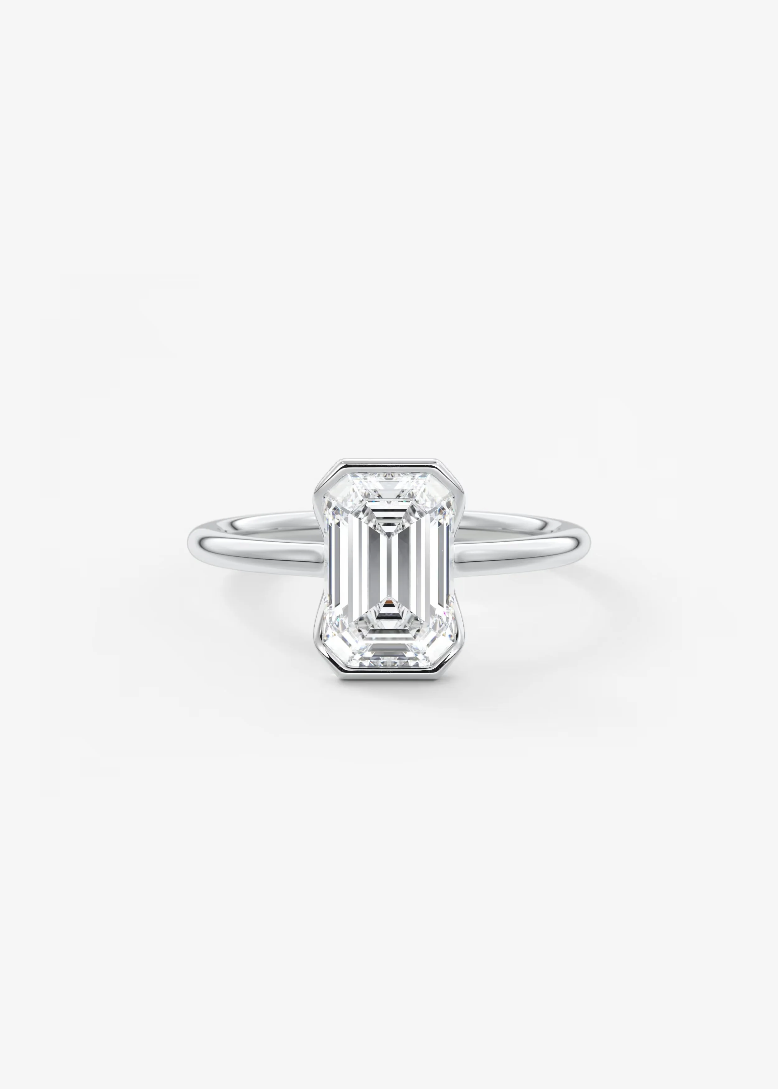 Runder Platinring mit großem, rechteckigem Diamanten in moderner Schliffgestaltung vor weißem Hintergrund.