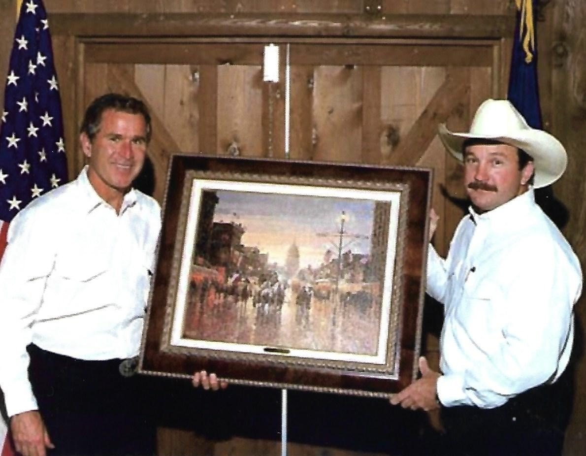 Jack Terry presenting one of his paintings to President George W. Bush.