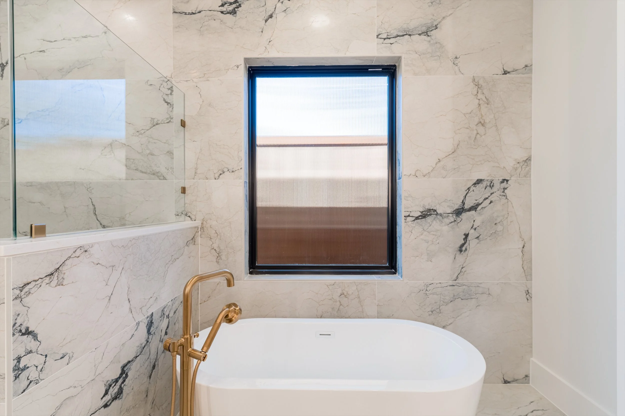Freestanding tub and marble shower at 13510 Crestmoor Dr.