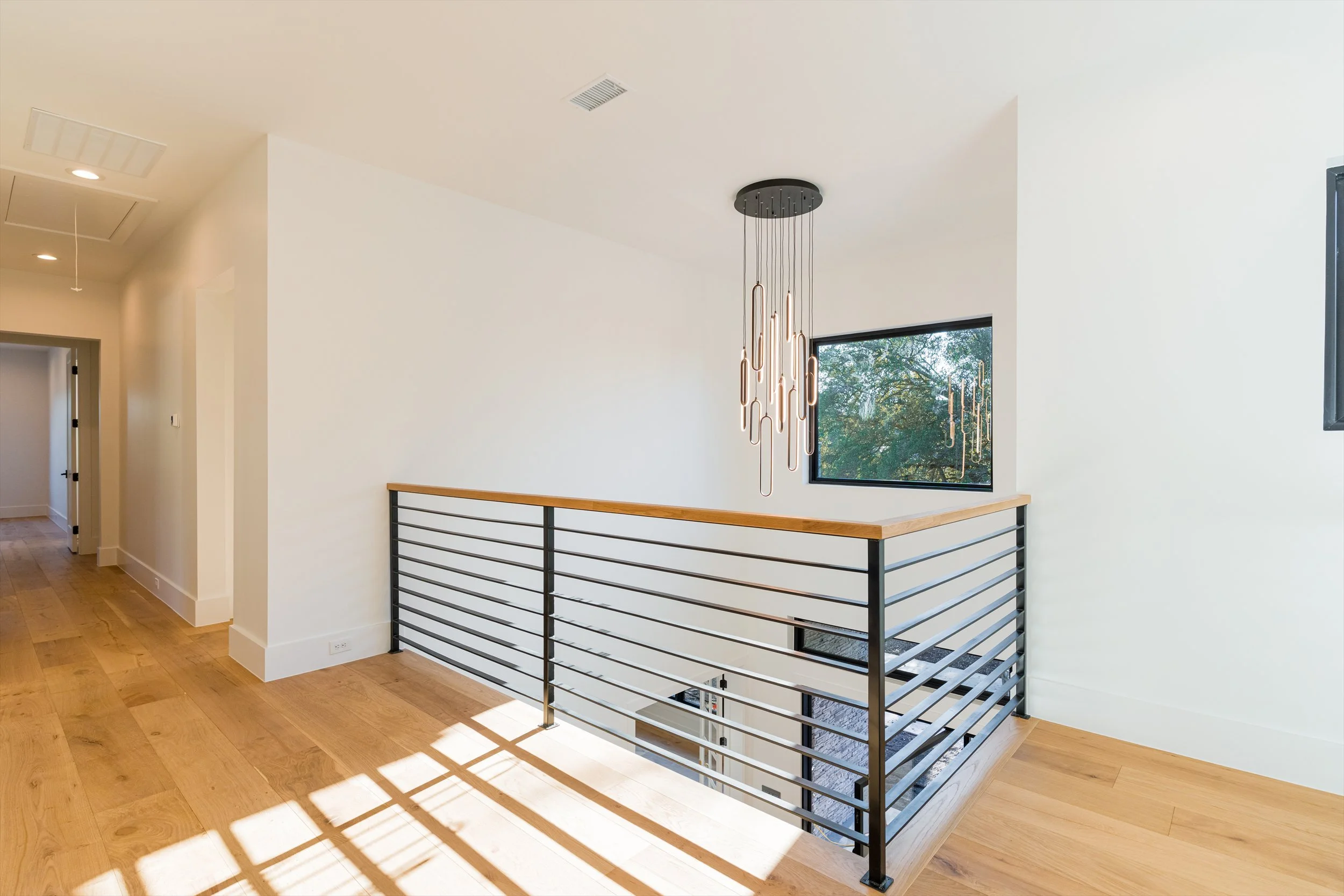 Upstairs landing and modern railing at 13510 Crestmoor Dr.