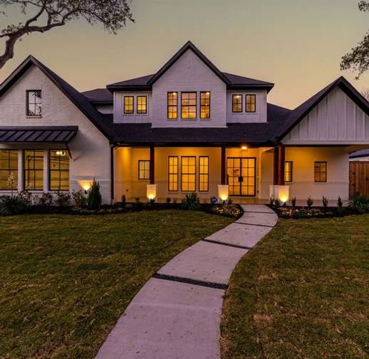 Front elevation at dusk of 13640 Littlecrest Dr custom home in Farmers Branch, Texas