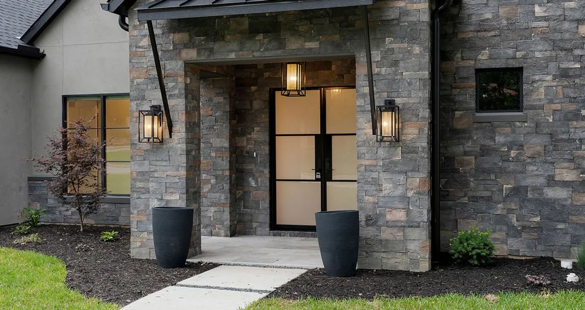 Stone entry and covered front door of 14467 Tanglewood Dr custom home in Farmers Branch, Texas