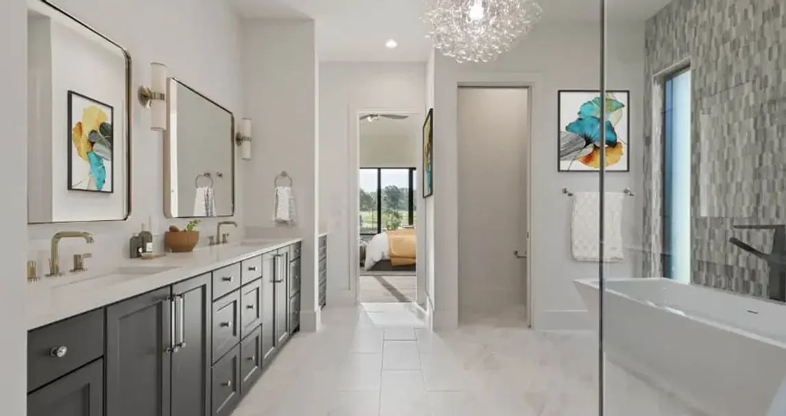 Primary bathroom with double vanity and soaking tub at 14310 Valley Hi Cir custom home in Farmers Branch, Texas