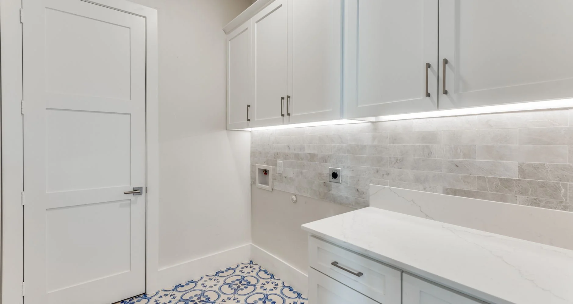 Primary bathroom with marble vanity, soaking tub, and patterned tile at 3510 Pebble Beach Dr custom home in Farmers Branch, Texas