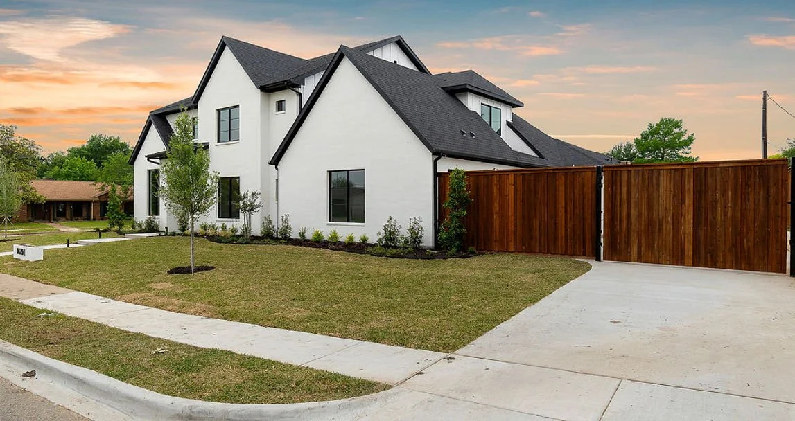 Front exterior of 14251 Southern Pines Dr custom home in Farmers Branch, Texas at sunset