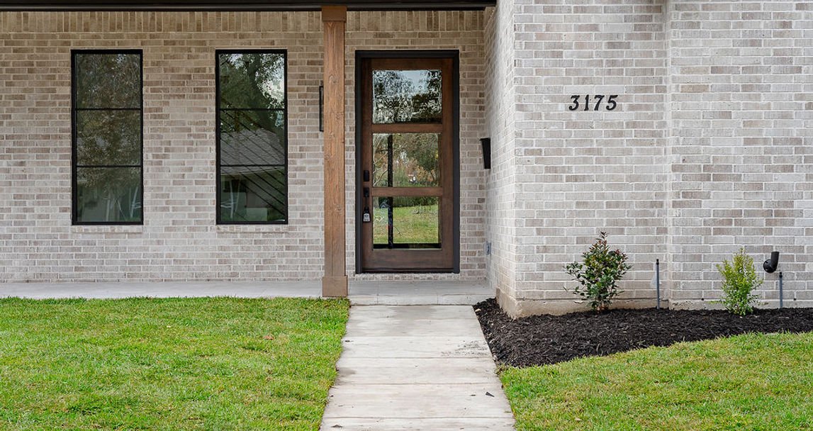 Brick entry and front door of 3175 Whitemarsh custom home in Farmers Branch, Texas