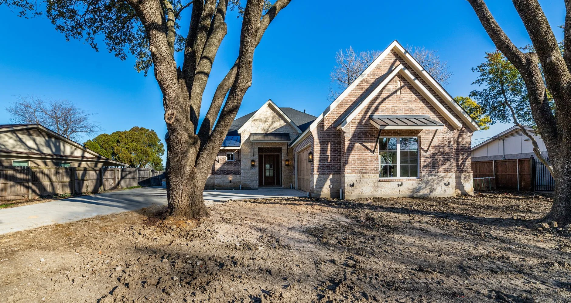 Front exterior of 3171 Golfing Green Dr traditional custom home near Brookhaven Country Club in Farmers Branch, Texas