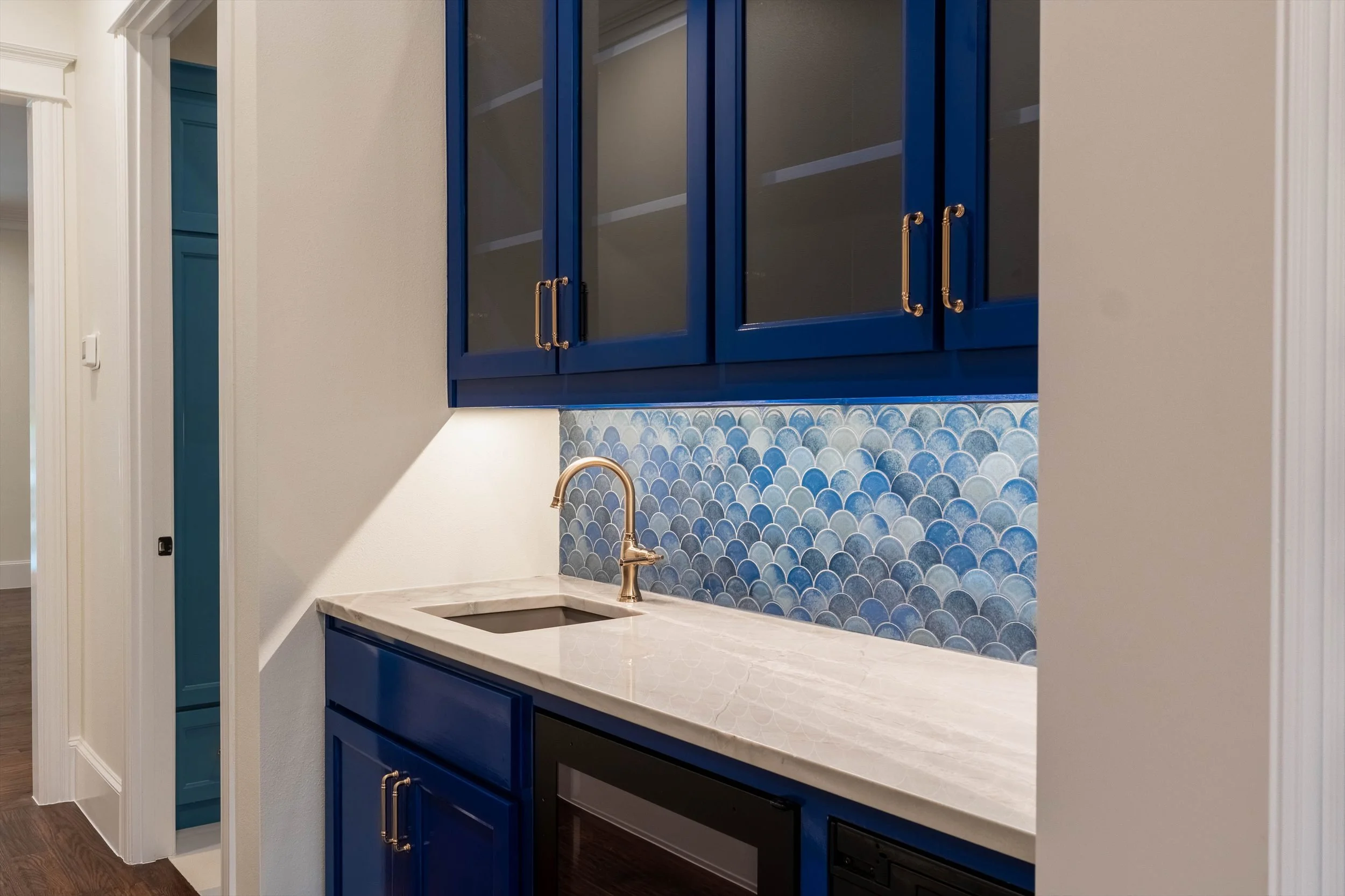  Blue cabinetry and marble countertop in a bathroom at 1095 Lathrop Dr custom home in Dallas, Texas 