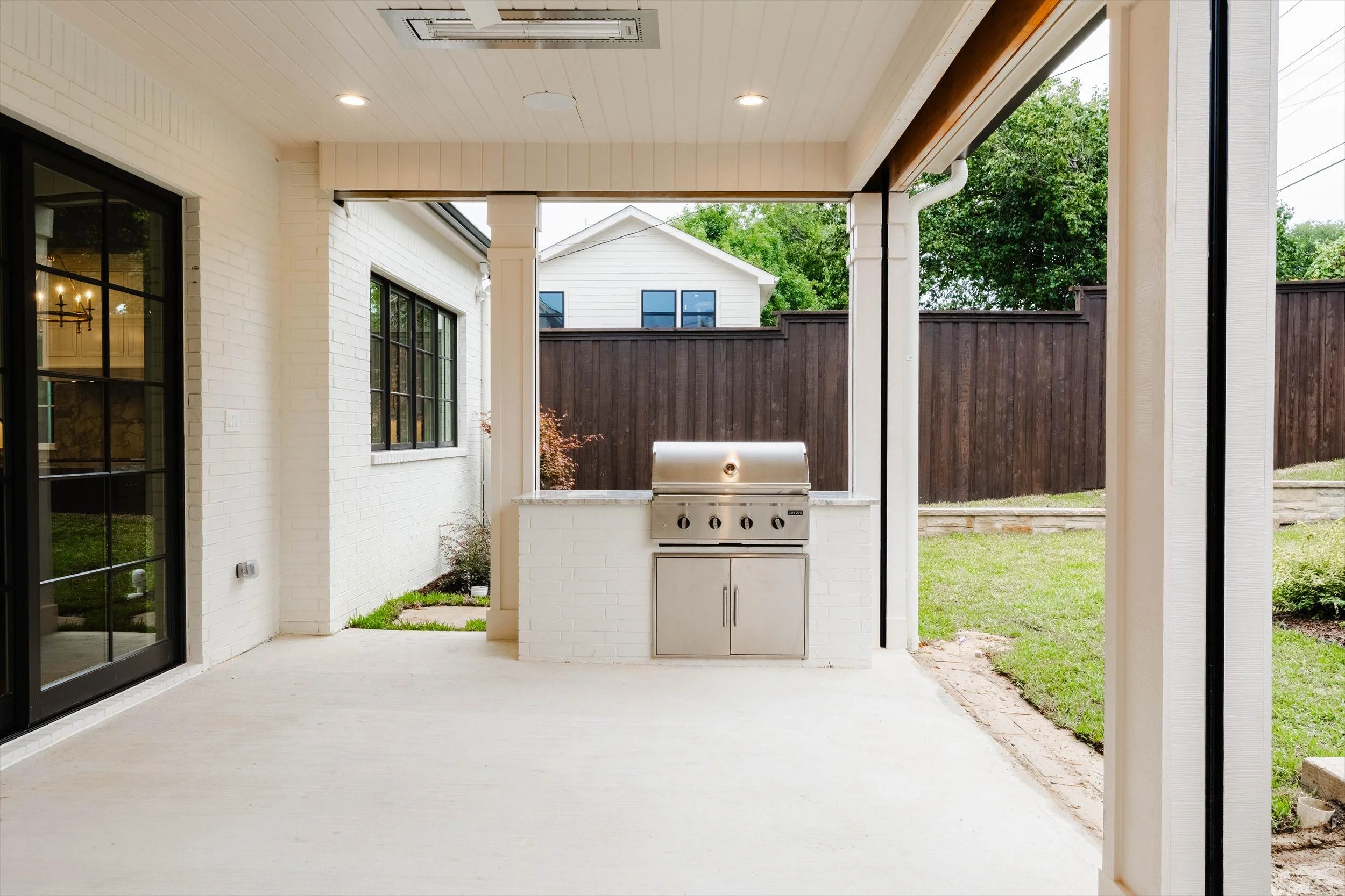  Covered patio with outdoor kitchen at 1095 Lathrop Dr custom home in Dallas, Texas 
