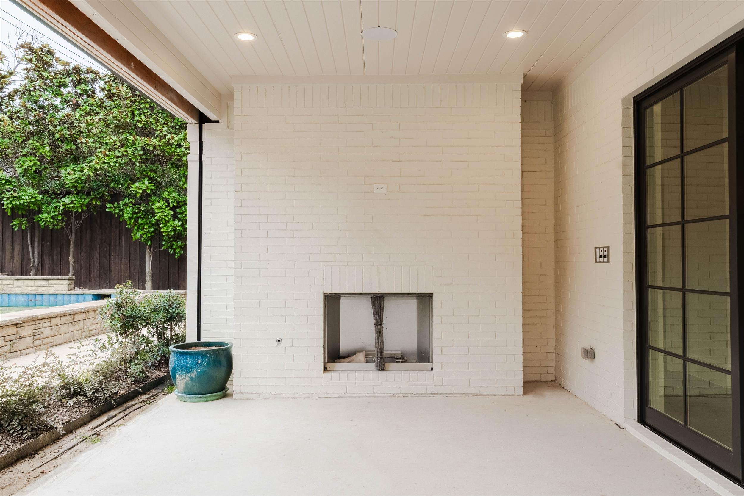 Covered patio with a fireplace and sliding glass doors at 1095 Lathrop Dr.
