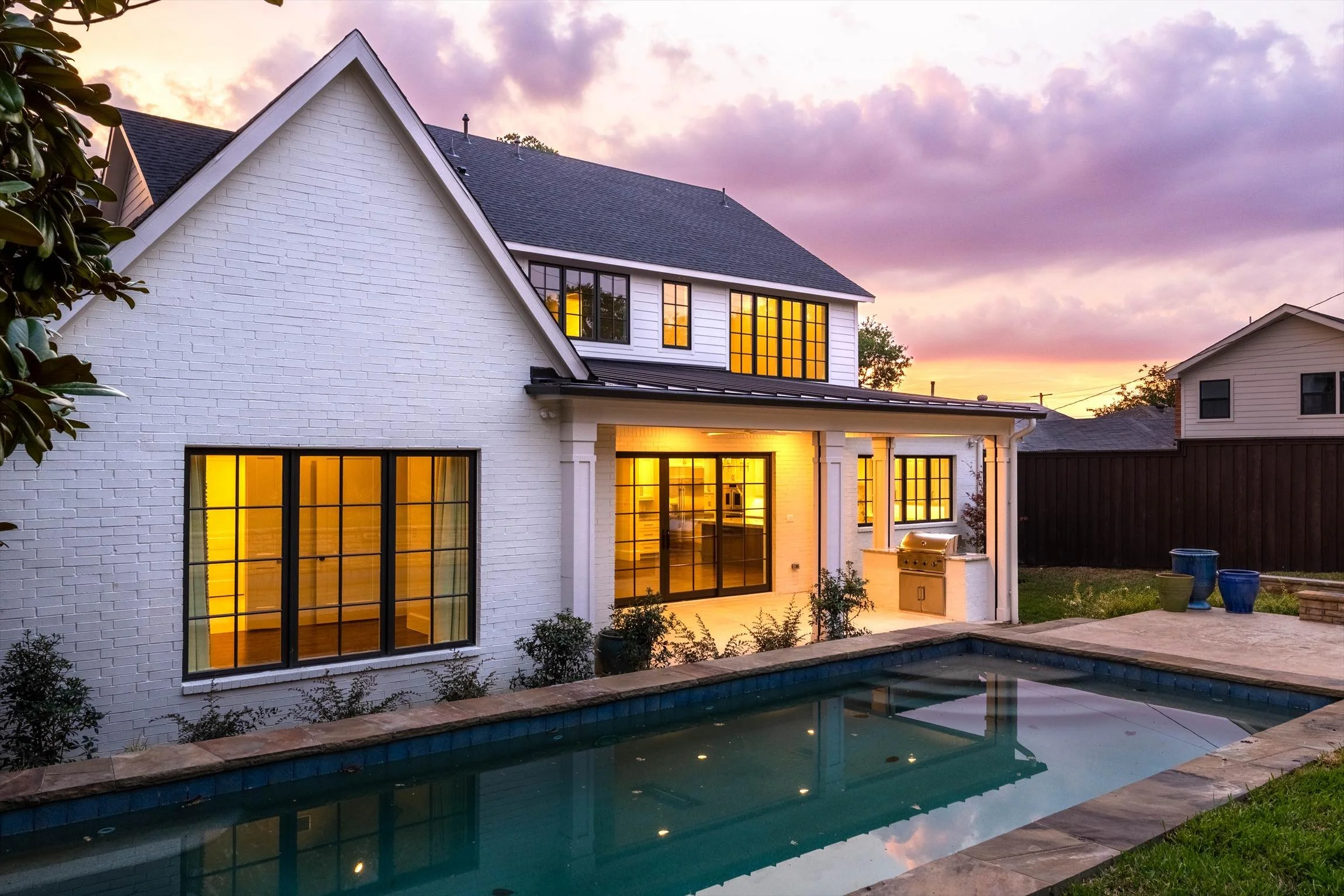 Rear exterior and swimming pool at dusk at 1095 Lathrop Dr.