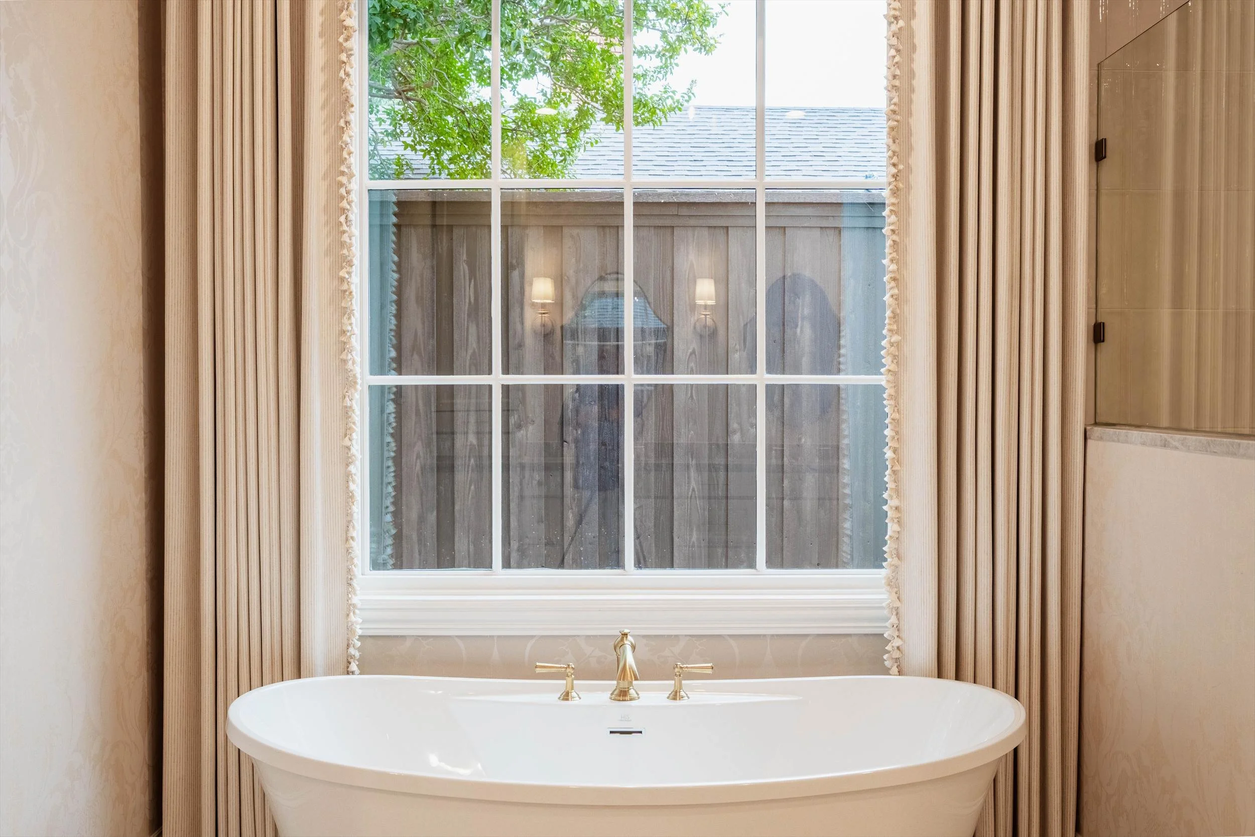Freestanding bathtub beneath a large window at 1095 Lathrop Dr.
