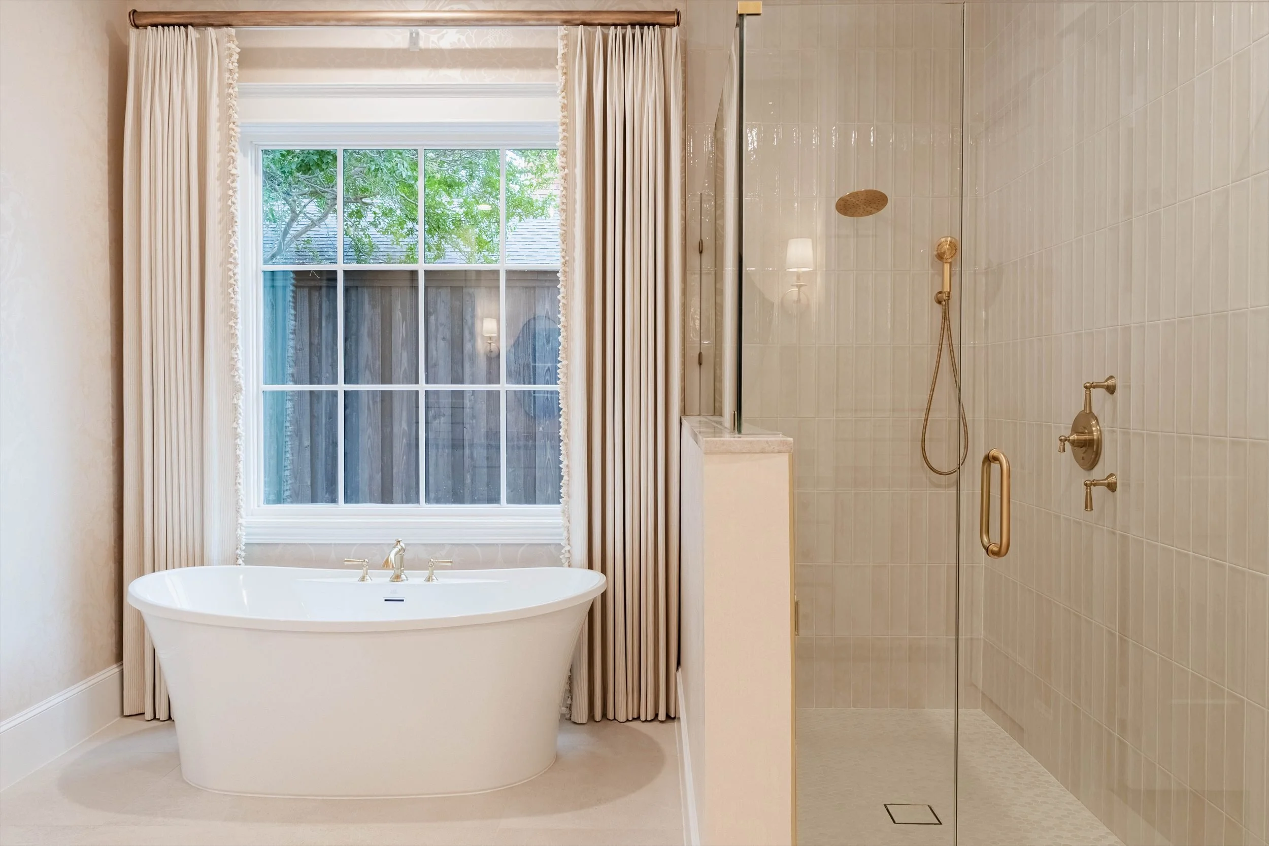 Bathroom with a freestanding bathtub and glass shower at 1095 Lathrop Dr.