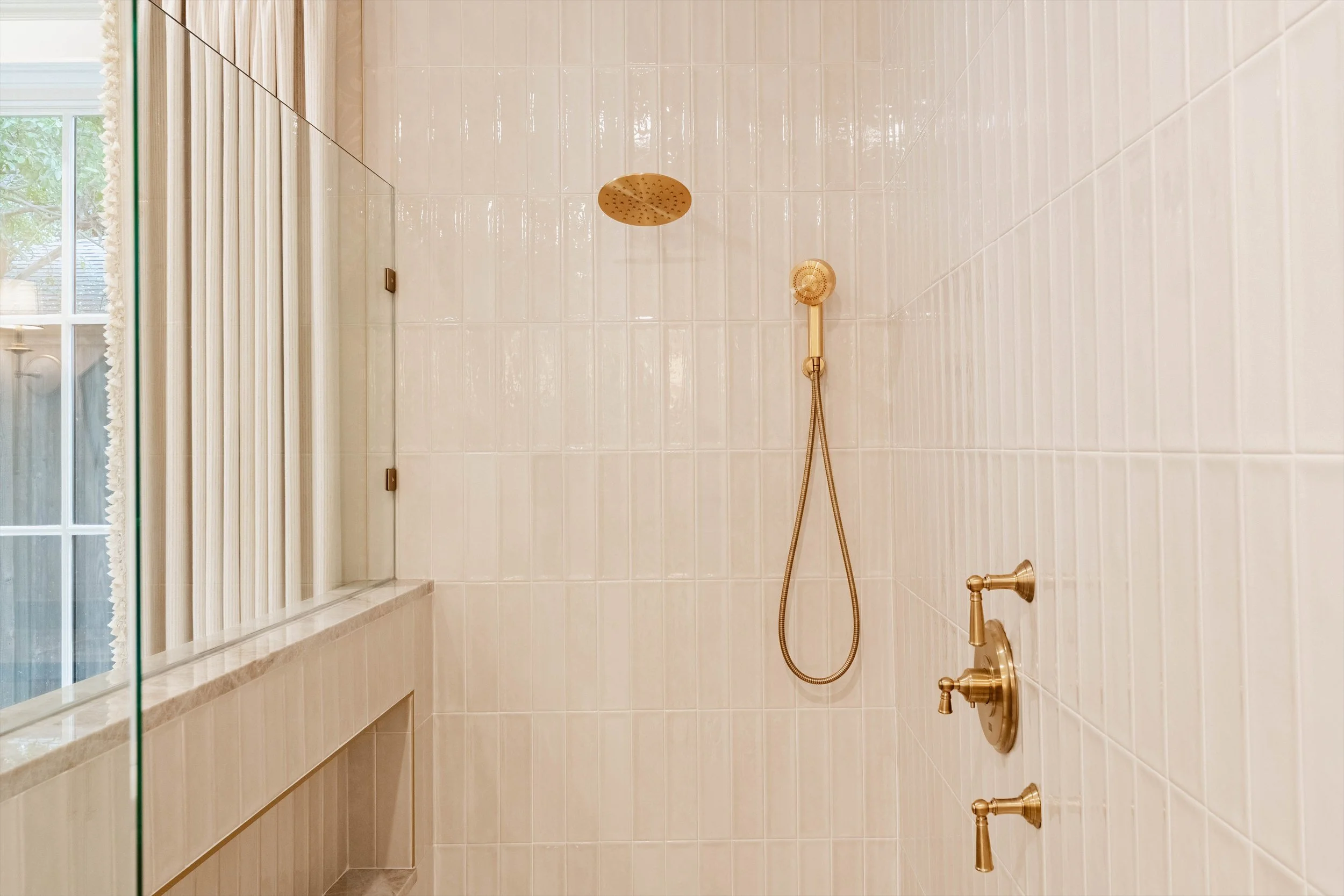 Walk-in shower with brass fixtures at 1095 Lathrop Dr.