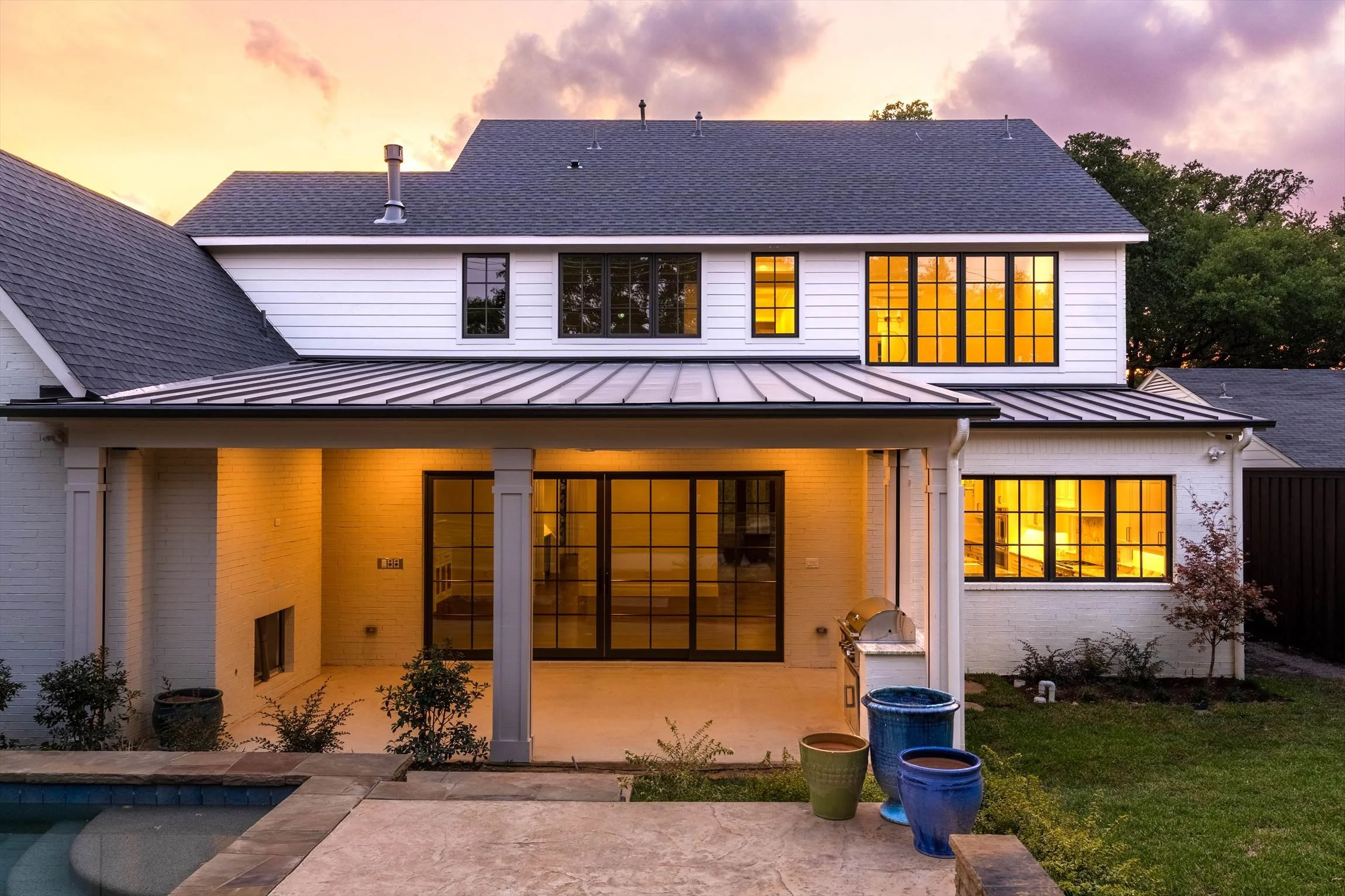 Rear exterior overlooking the swimming pool at dusk at 1095 Lathrop Dr.