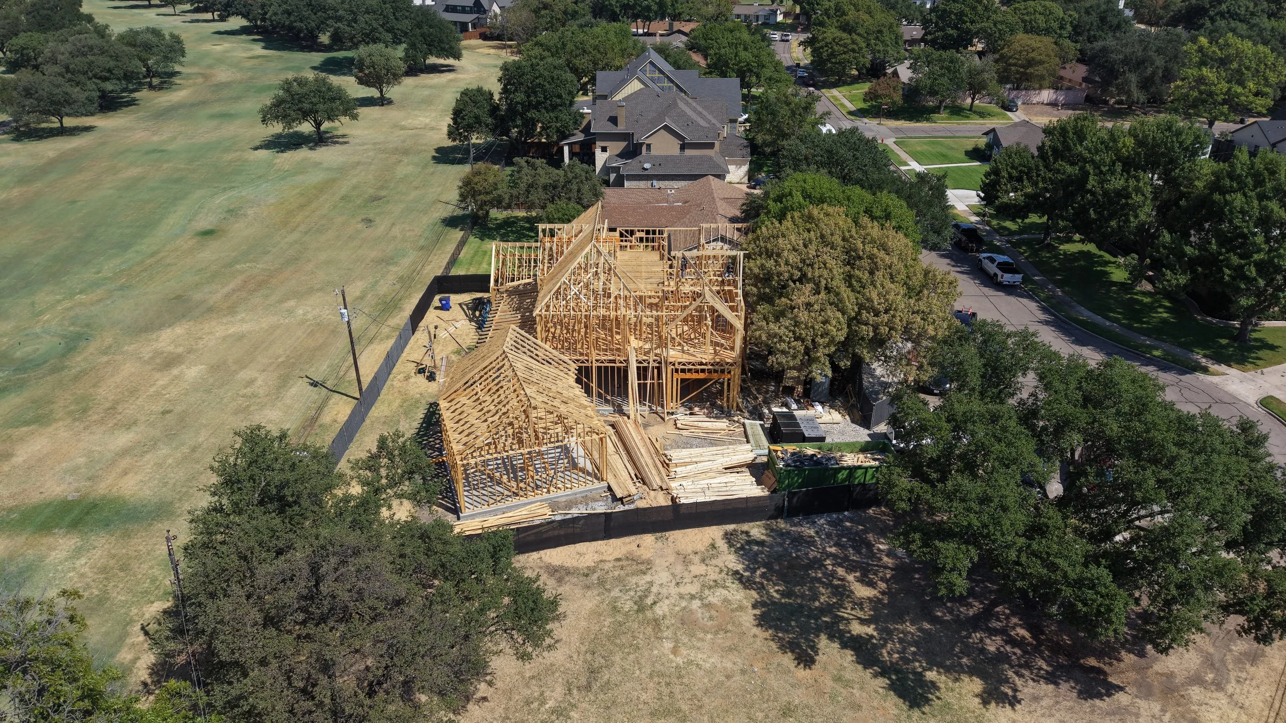 Side aerial view of the framed home beside a golf fairway at 14211 Coral Harbour Cir