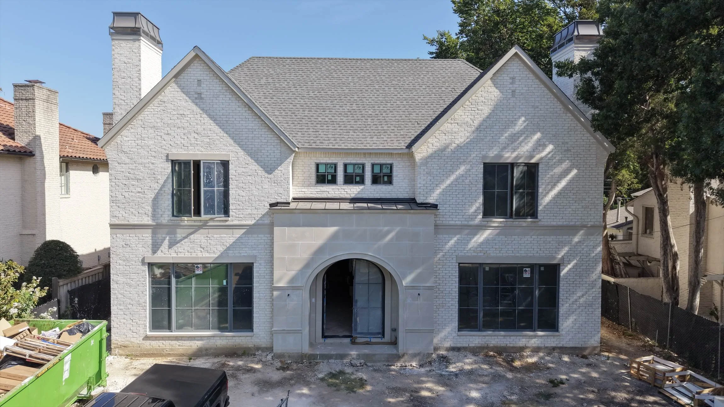 Front elevation with arched entry under construction at 4004 Bryn Mawr Dr in Dallas, Texas.