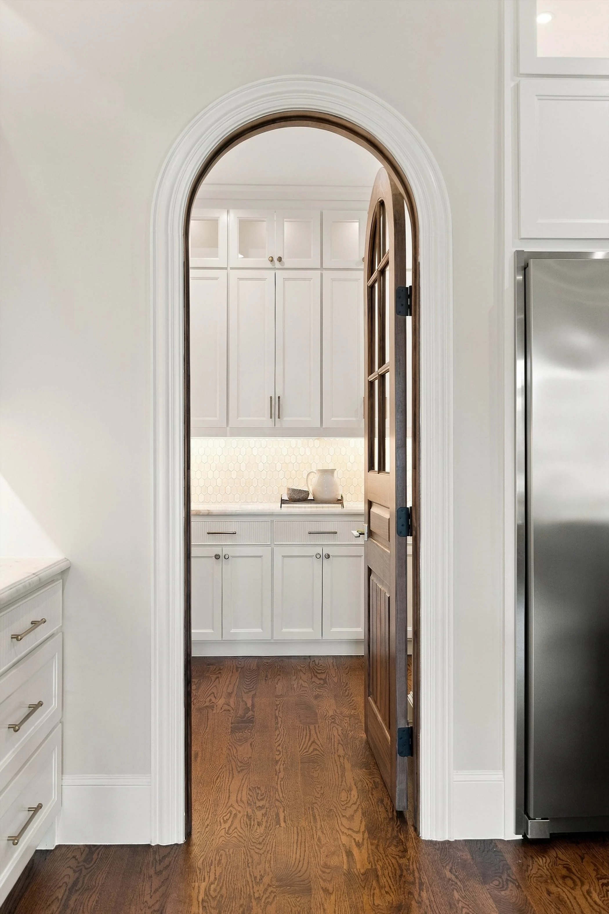 Arched doorway to pantry cabinetry at 3368 Dorado Beach Dr in Dallas, Texas.