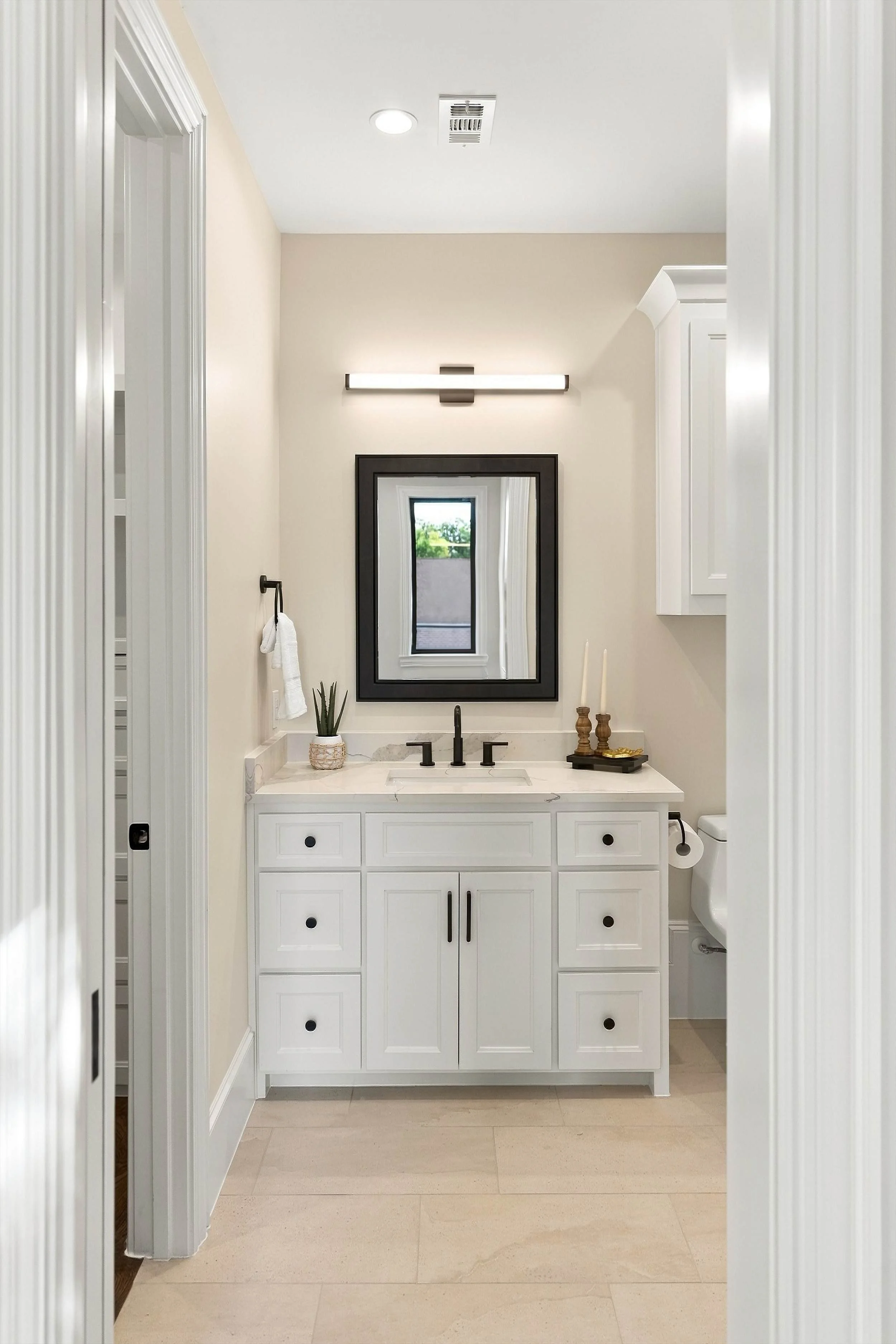 Bathroom vanity beyond hallway at 3368 Dorado Beach Dr in Dallas, Texas.