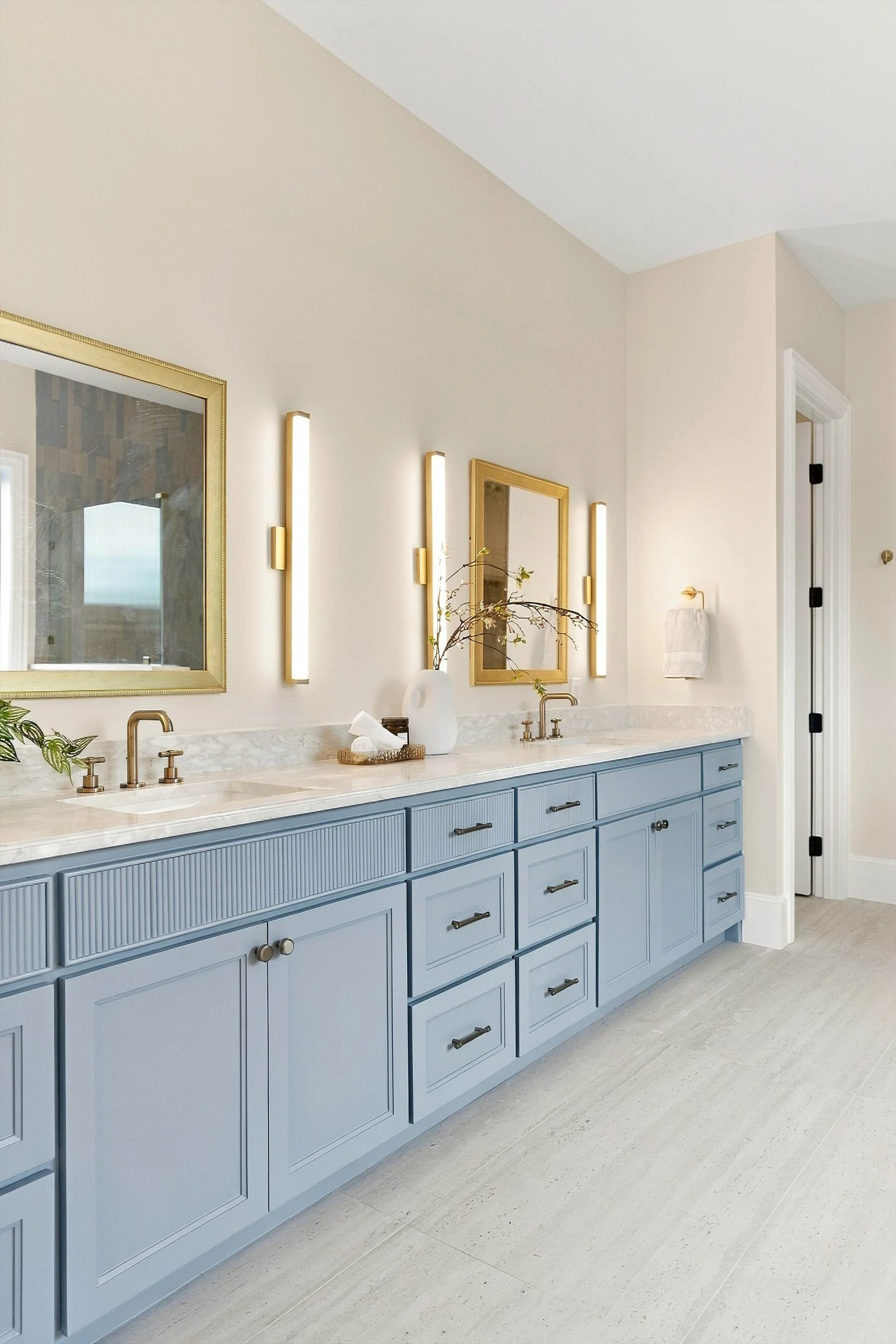 Bathroom with double vanity and gold fixtures at 3368 Dorado Beach Dr in Dallas, Texas.