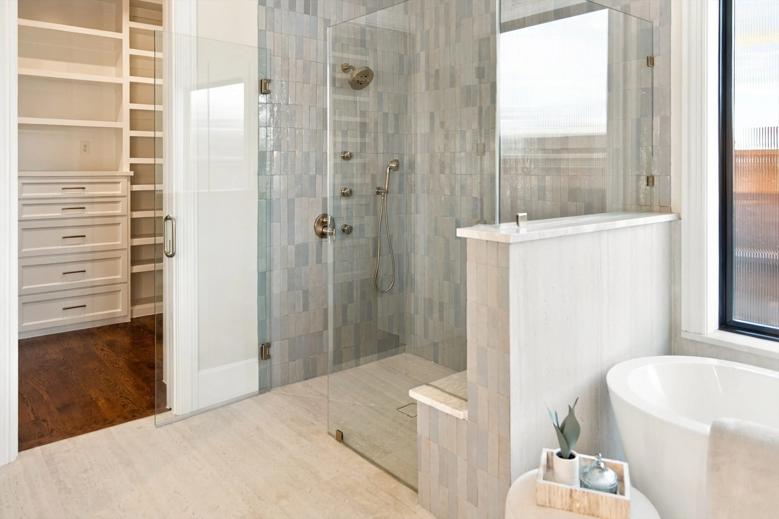 Bathroom with glass shower and freestanding tub at 3368 Dorado Beach Dr in Dallas, Texas.