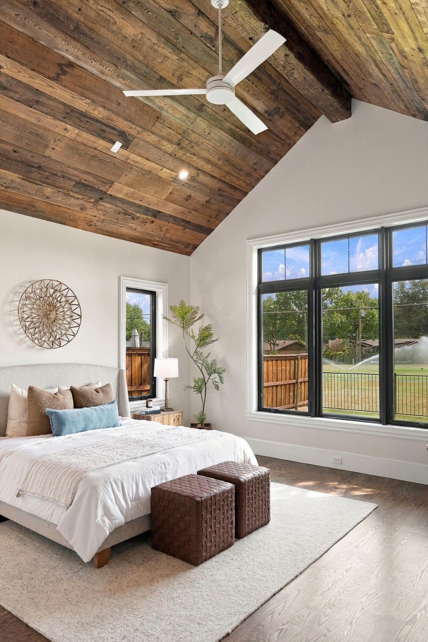 Bedroom with wood ceiling and large windows at 3368 Dorado Beach Dr in Dallas, Texas.