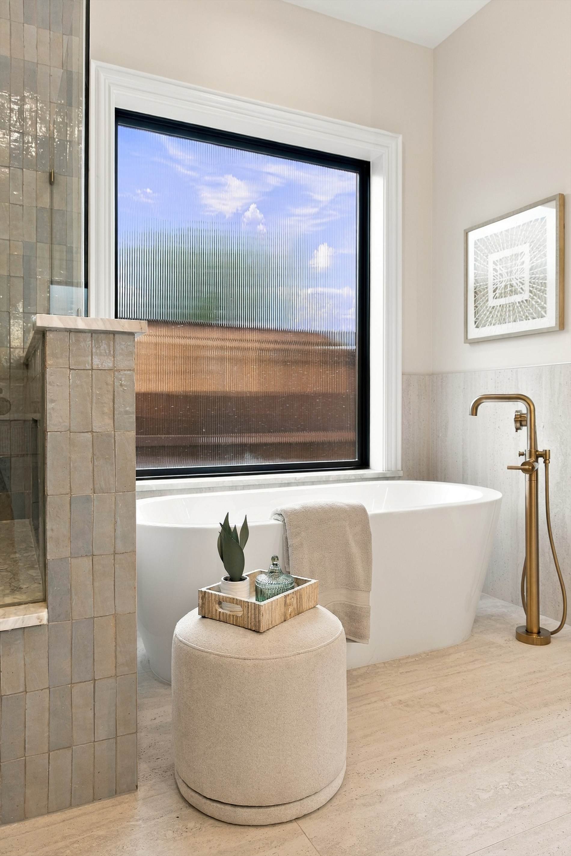 Freestanding bathtub beneath large window at 3368 Dorado Beach Dr in Dallas, Texas.