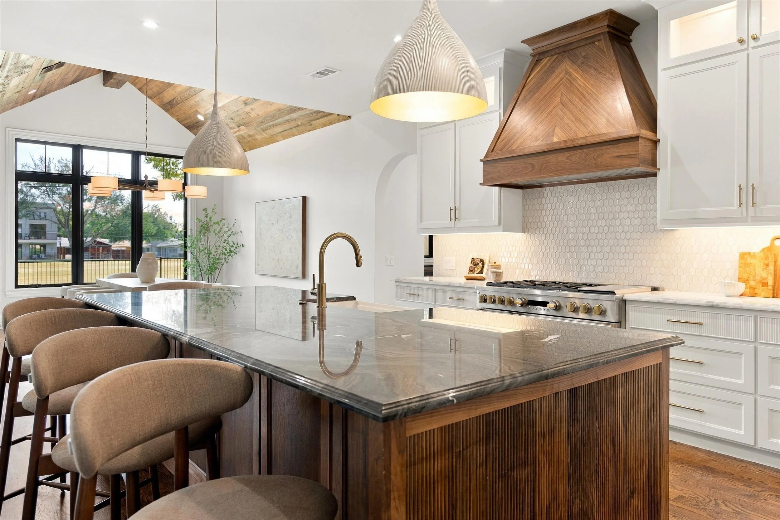 Kitchen island seating and pendant lighting at 3368 Dorado Beach Dr in Dallas, Texas.