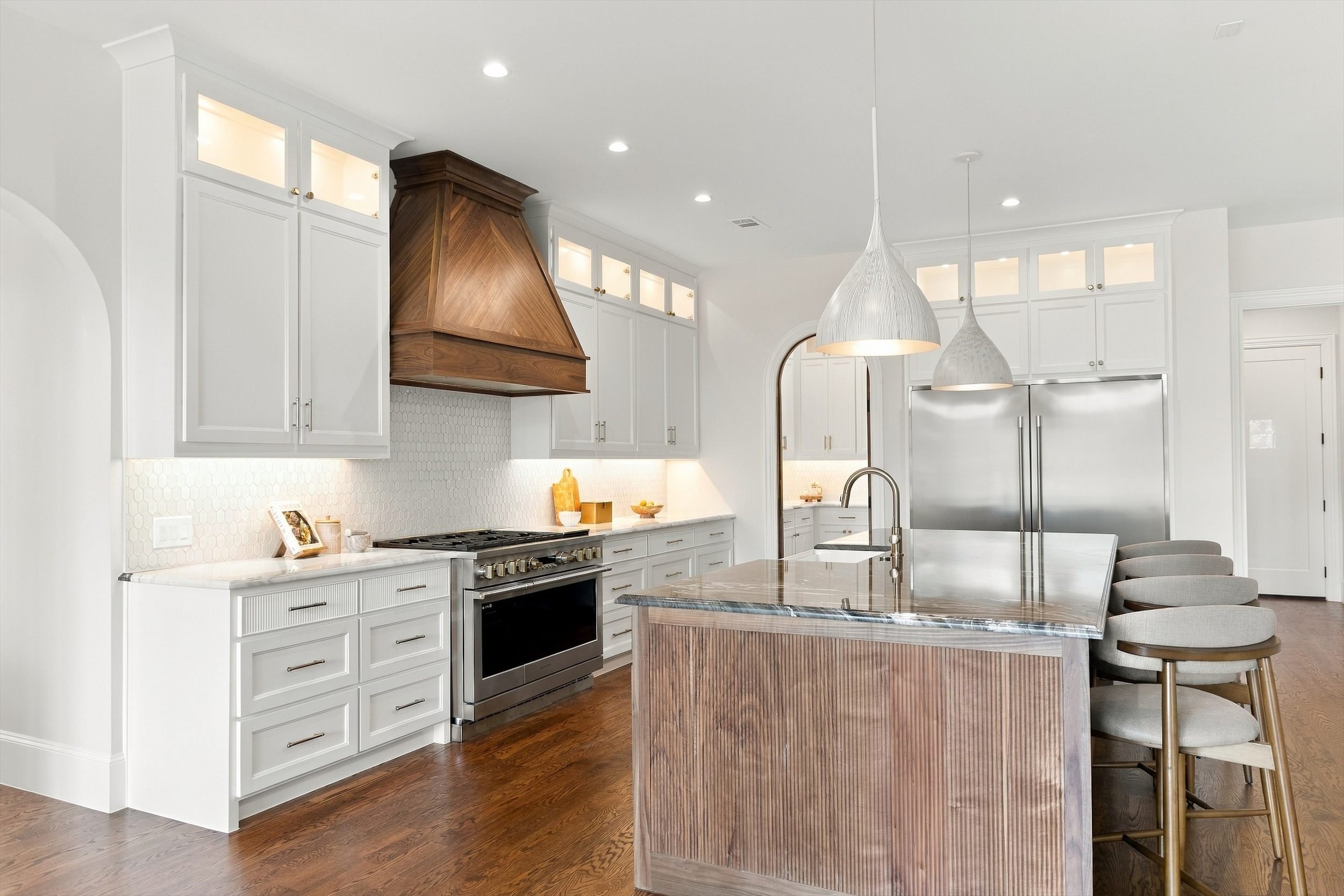 Kitchen with walnut island and wood range hood at 3368 Dorado Beach Dr in Dallas, Texas.