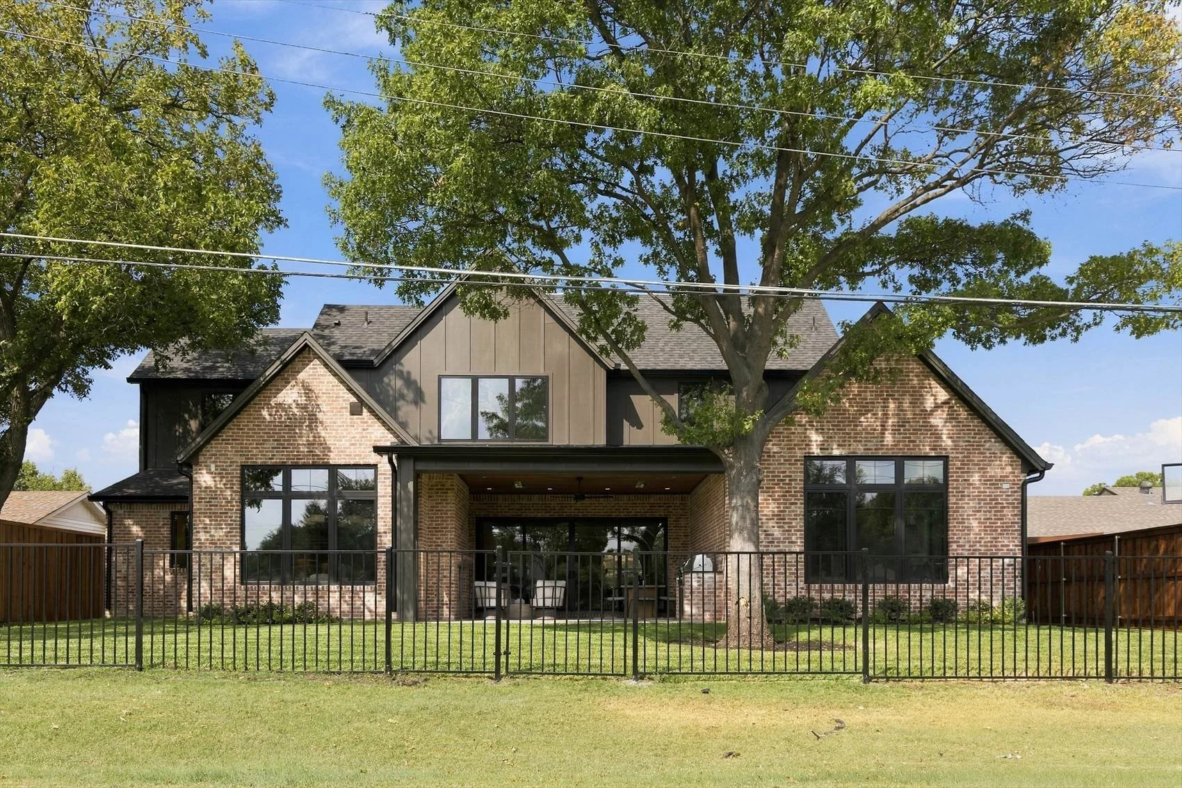 Rear exterior with fenced yard at 3368 Dorado Beach Dr in Dallas, Texas.