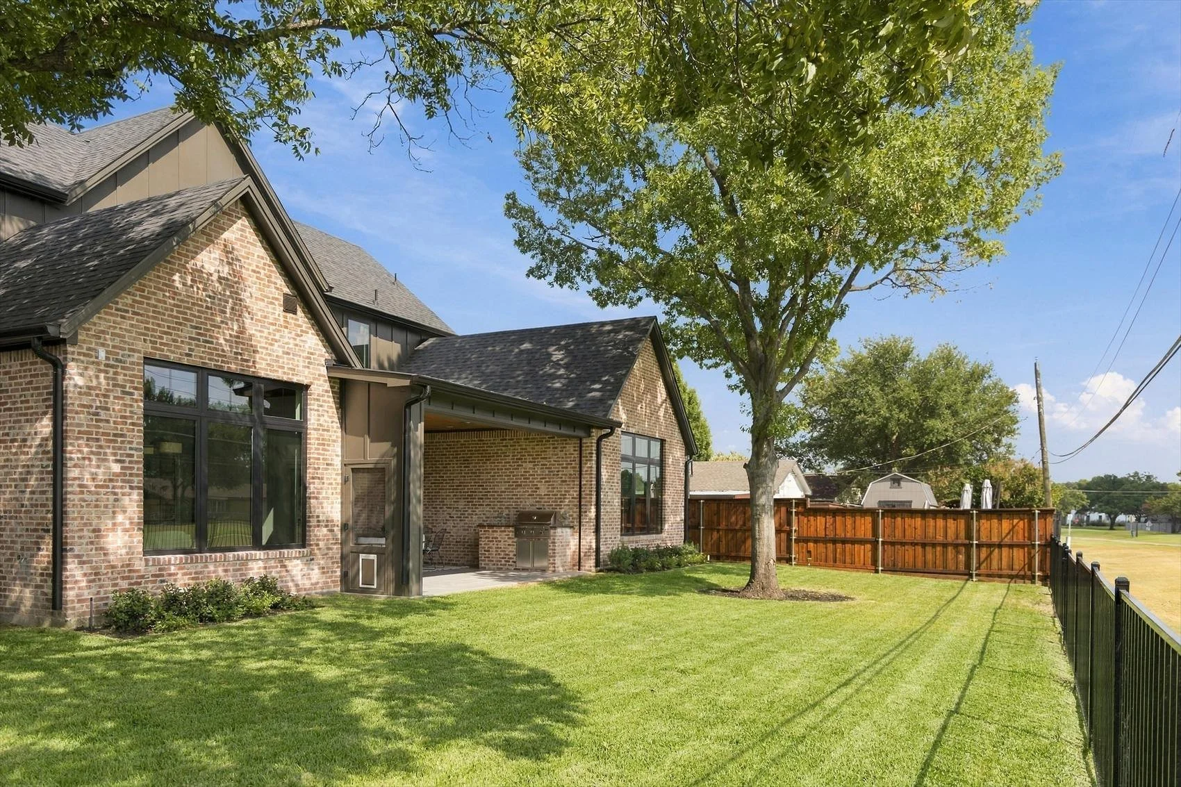 Rear lawn and covered outdoor living area at 3368 Dorado Beach Dr in Dallas, Texas.