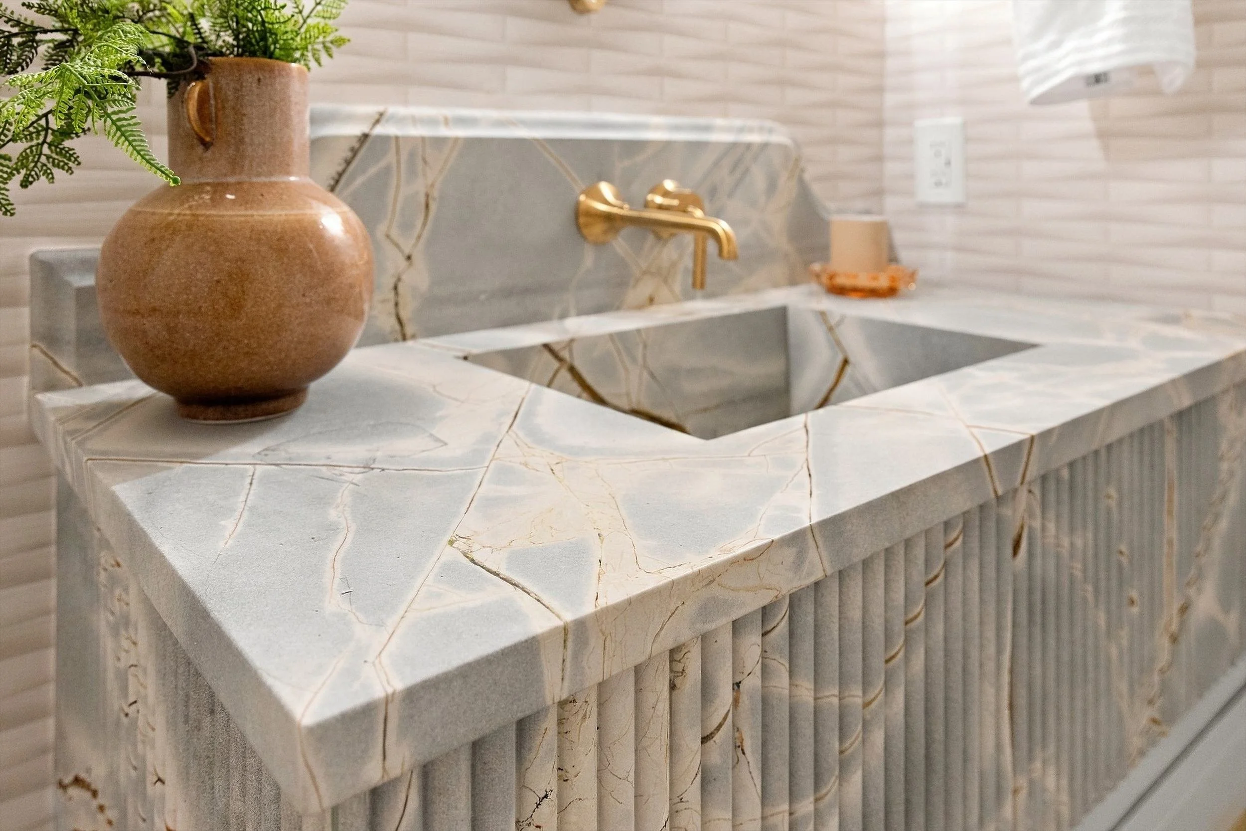 Stone sink and fluted vanity detail at 3368 Dorado Beach Dr in Dallas, Texas.