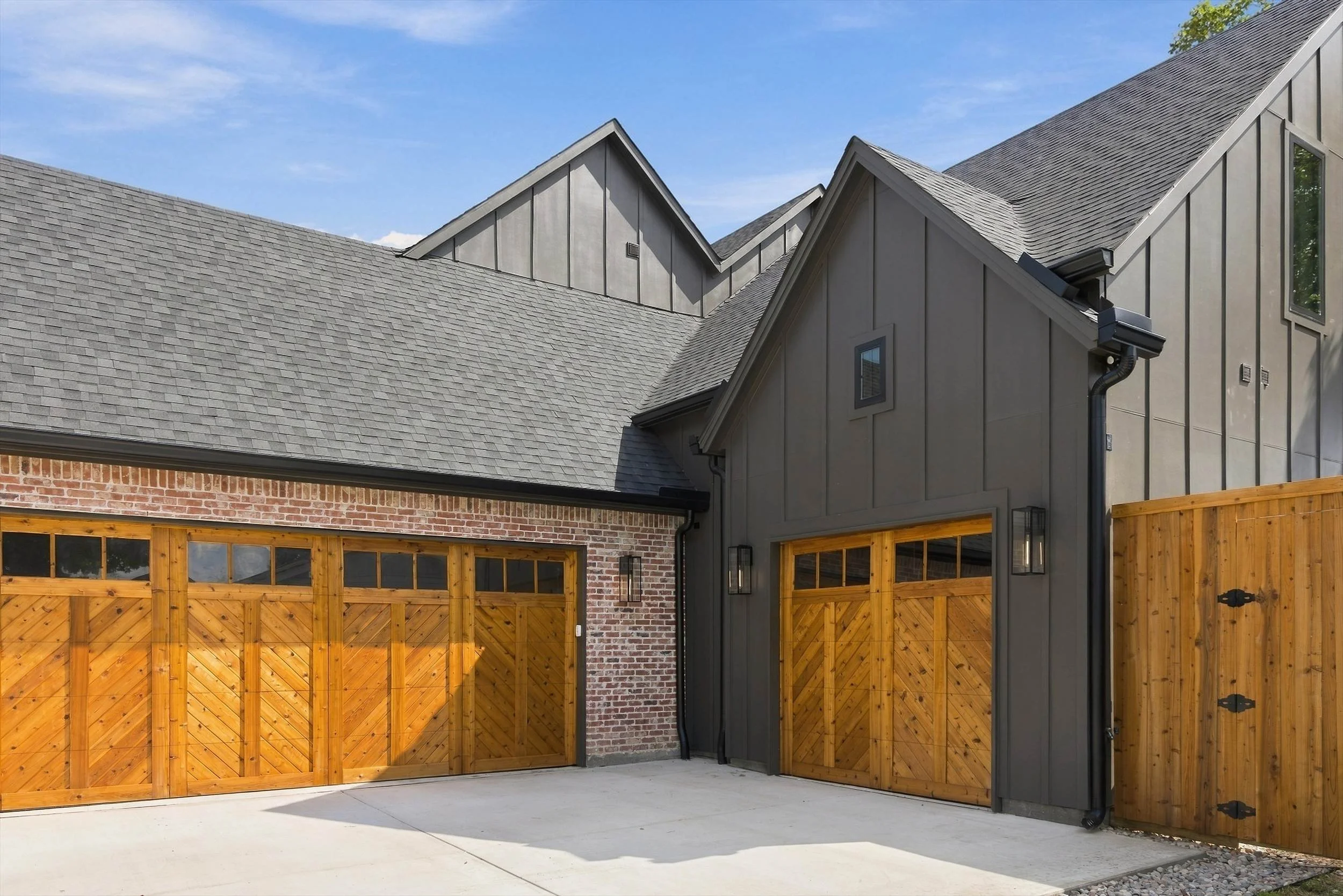 Wood garage doors and concrete driveway at 3368 Dorado Beach Dr in Dallas, Texas.