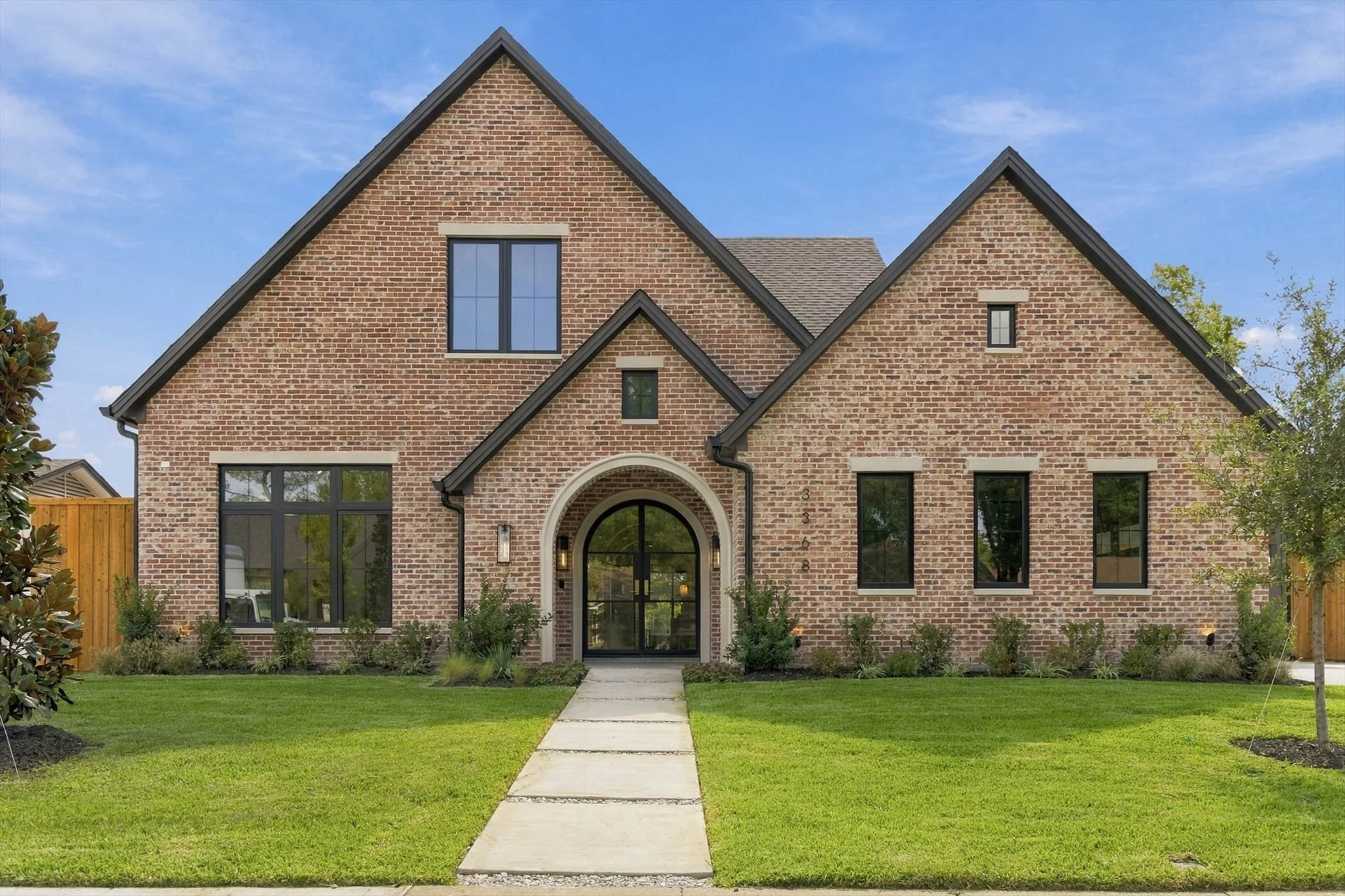 Front exterior with brick facade and arched entrance at 3368 Dorado Beach Dr in Dallas, Texas.