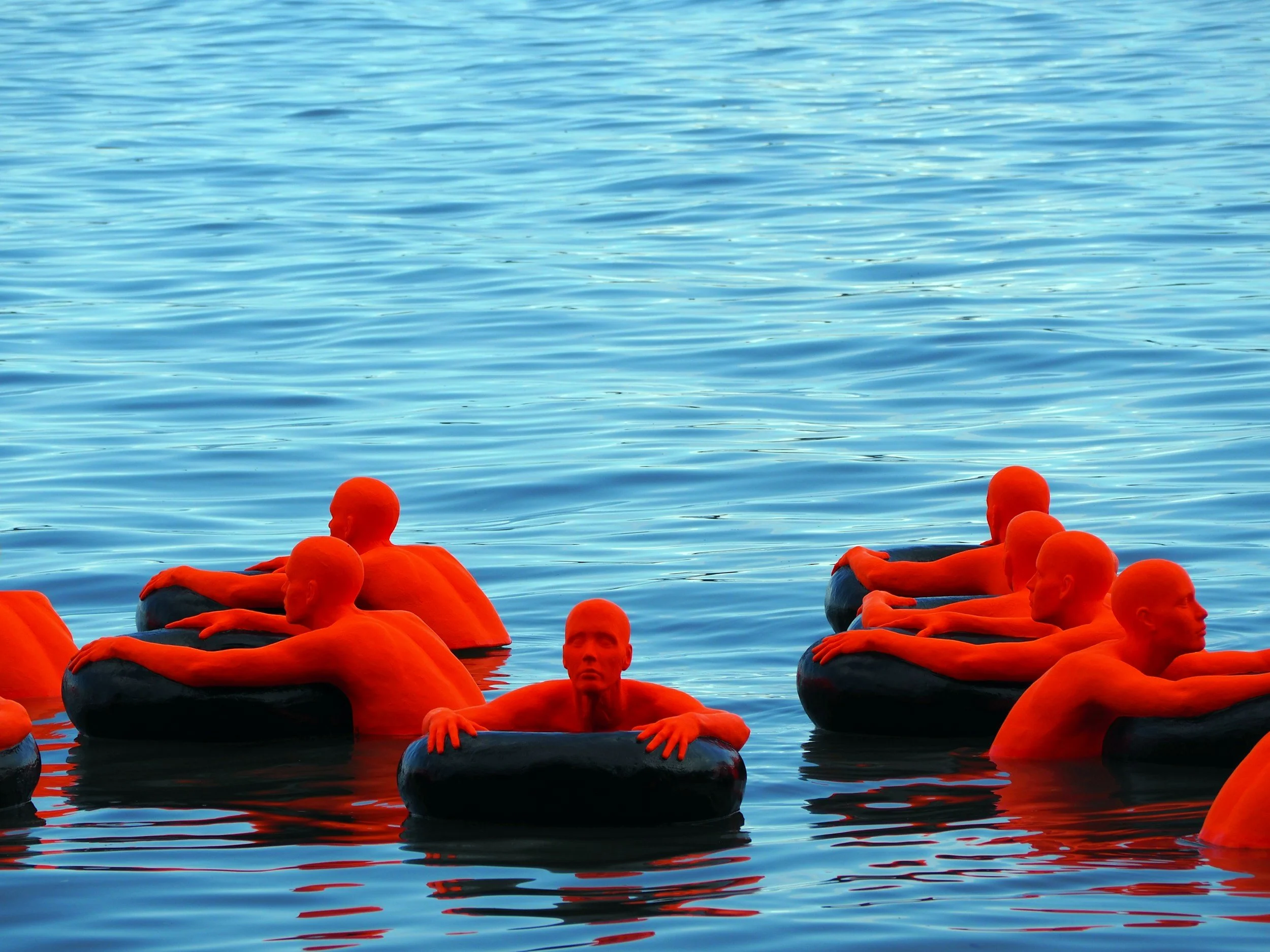red mannequins in water