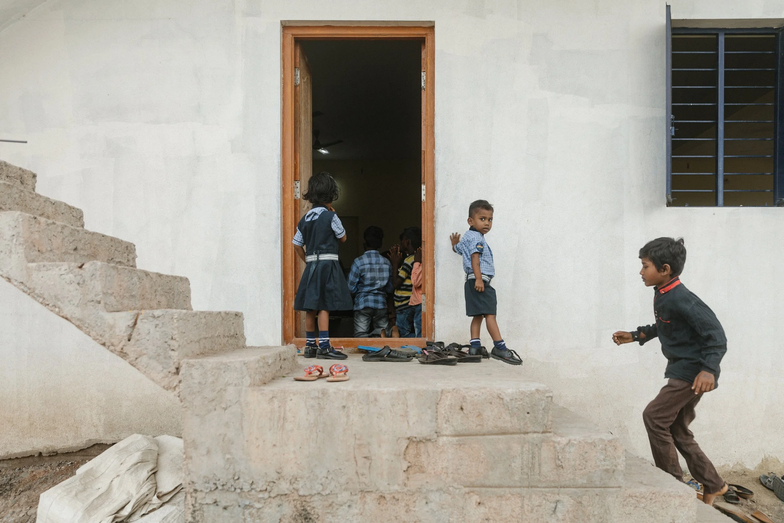 Boys and girls outside of sponsor house in india
